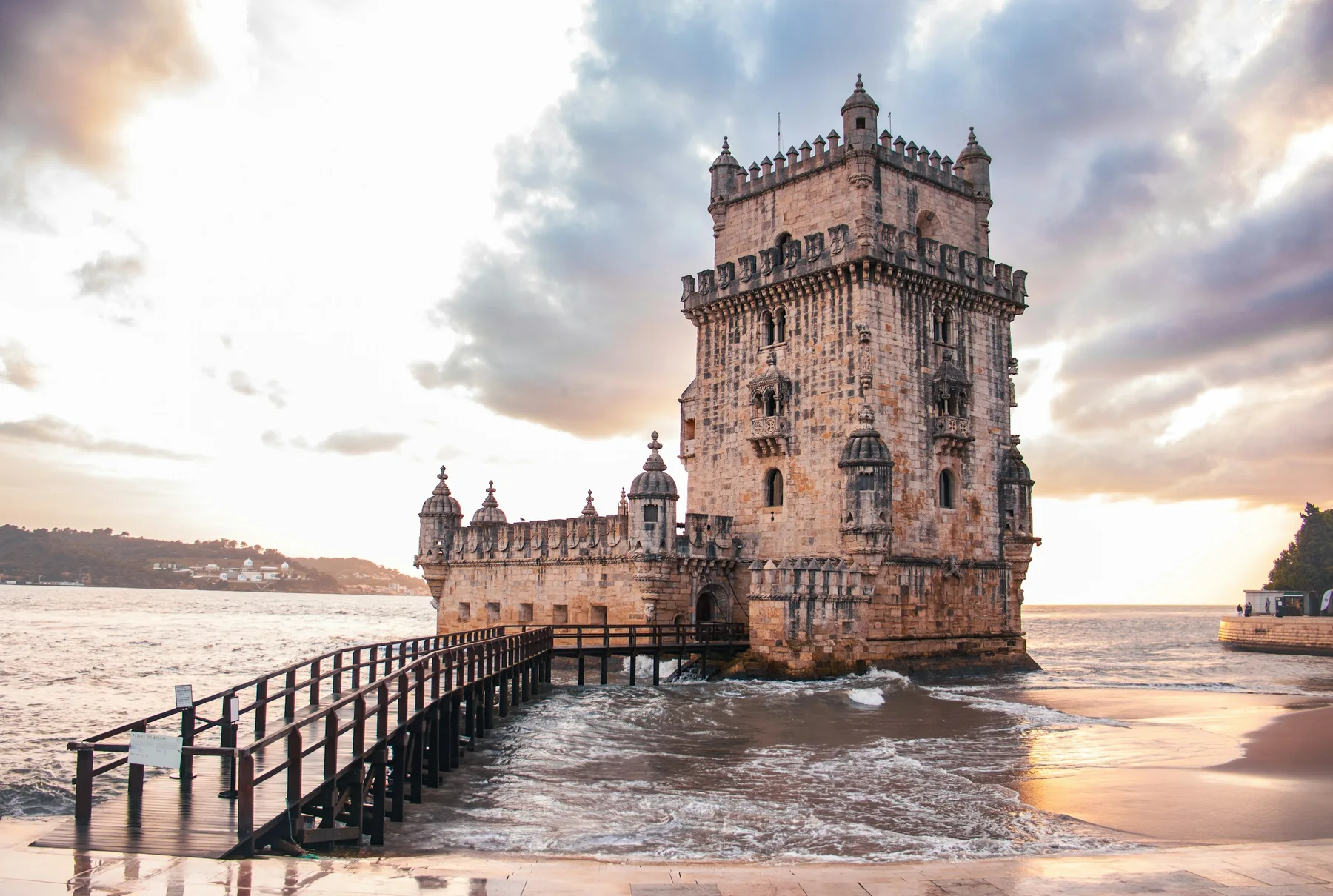 Belém Tower and the Tagus waterfront in warm evening light.
